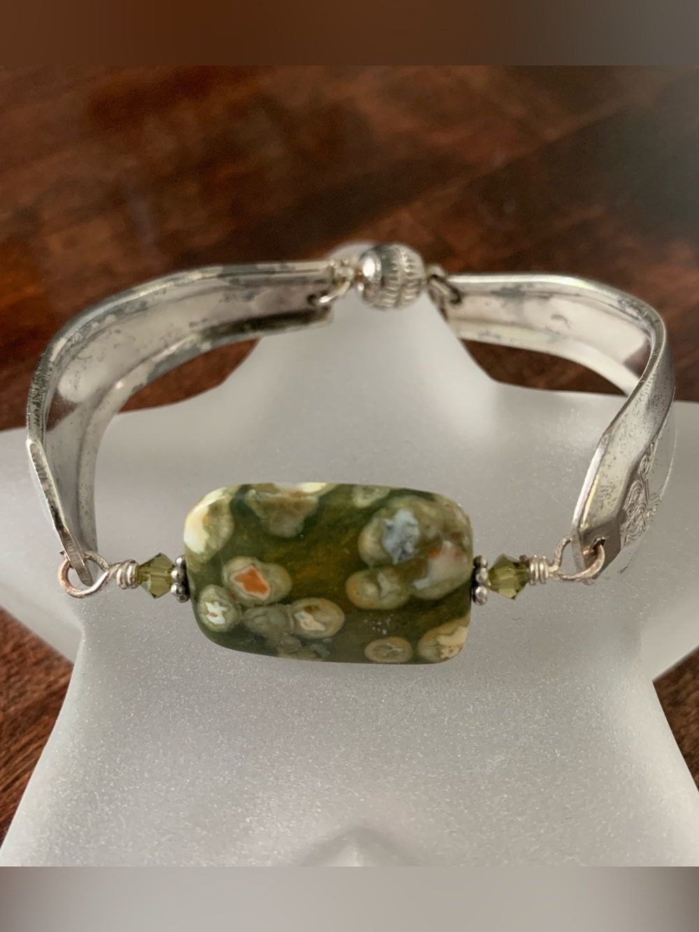 Artisan made spoon handle bracelet with green center stone